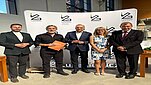 grupa ludzi ubranych formalnie stoi obok siebie
